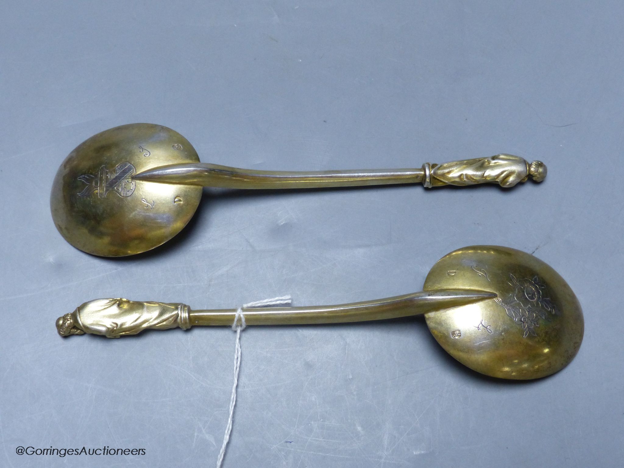 A pair of 19th century Hungarian? gilt white metal apostle spoons, 19.1cm, with engraved crests, 137 grams.